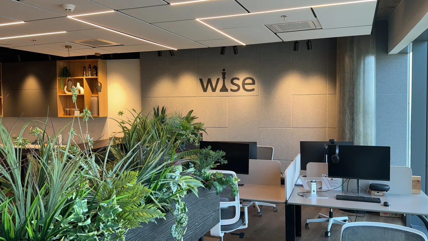 The Wise workspace with plants, desks and the company logo